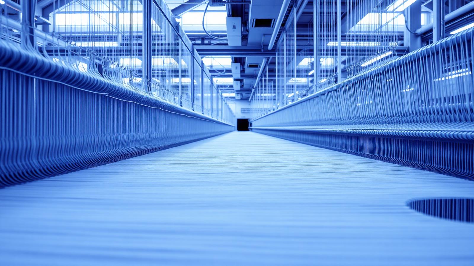 Warp yarn threads inside a modern textile weaving mill
